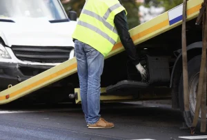 local towing service loading a car on a flatbed tow truck