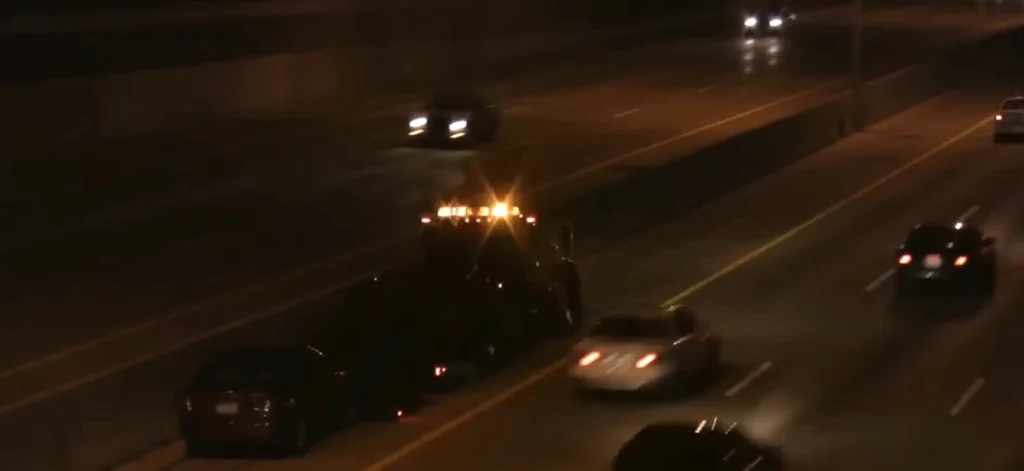 tow truck driving down highway at night
